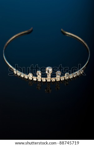 stock photo Tiara on black background with reflection and blue lights
