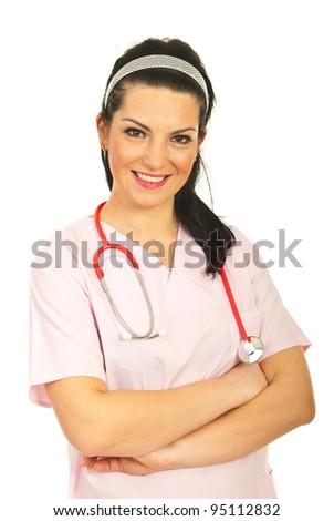 Friendly medical nurse woman in pink uniform standing with arms folded