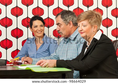 Business people sitting at meeting table and having conversation