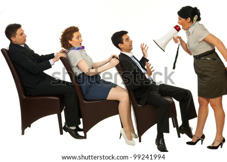 Furious manager shouting through megaphone to amazed employees on chairs against white background