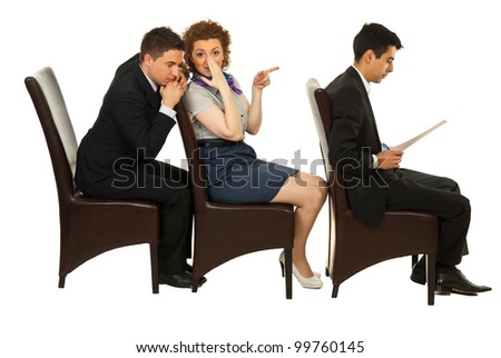 Businesswoman telling secret about first colleague man on chair to business an who listening her with closed eyes  and sitting all in a row on chairs