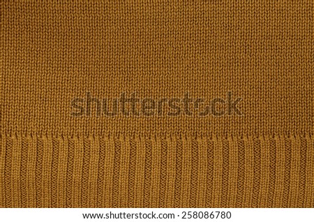 close up of a rust colored knitted background pattern, knitted right and left, detail / Rust colored knitted Background Pattern