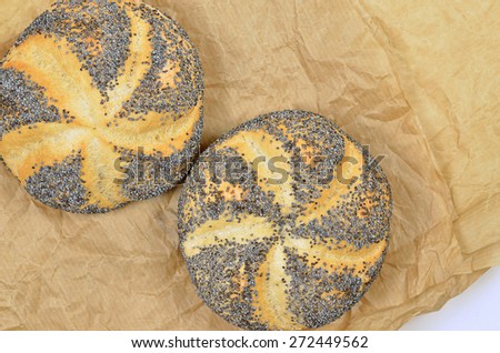 close up of two poppy seed rolls on greaseproof paper, detail, macro, full frame, horizontal / Poppy Seed Rolls
