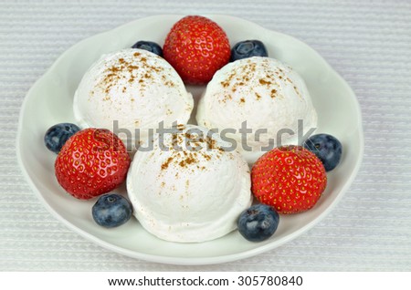 close up of a white plate with vanilla ice cream,  strawberries and blueberries, macro, detail, horizontal / Vanilla Ice Cream with Strawberries and Blueberries