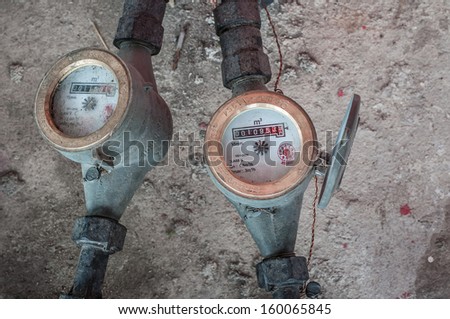 two old water meters on concreat background