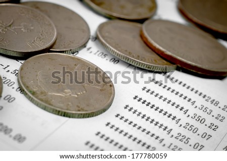 Close up of old coins and bank statement paper
