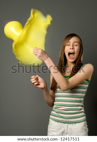 stock photo : The girl pierces a pin a balloon (high speed photography)