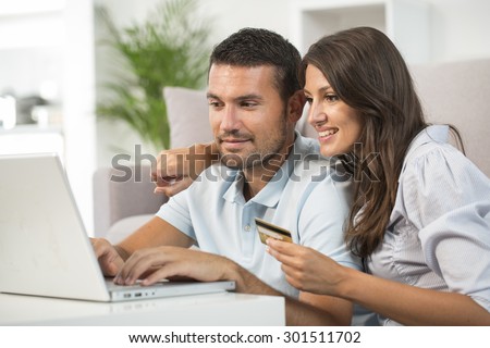 Couple using credit card to shop on line