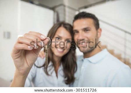 happy couple with key of new home
