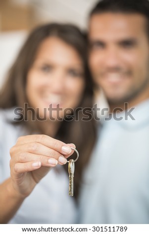happy couple with key of new home