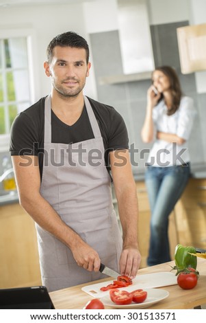 Young couple in kitchen preparing lunch