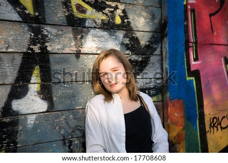 girl posing in front of a graffiti