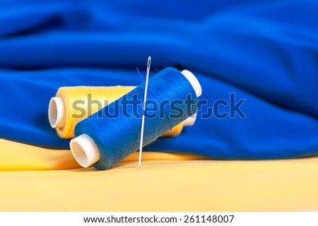 Colored threads and needles on tissue