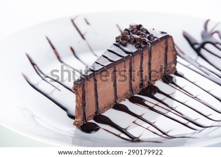 Dessert chocolate cake with topping and nuts on a white background