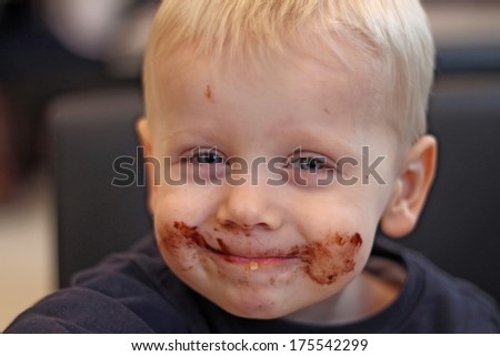 Boy ate chocolate and smudged his face