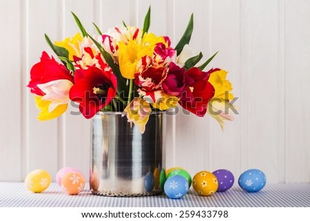 Spring easter tulips in bucket on white vintage planks