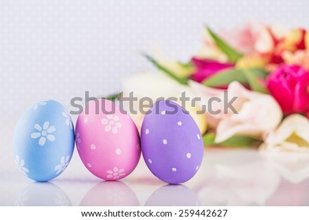 Easter eggs and tulips bunch beside