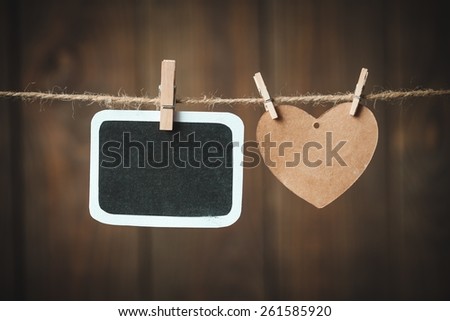 Day. Happy mothers Day message written on a black blackboard handling on rope with wooden heart