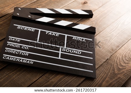 Cinema. vintage photo of movie clapper on wood