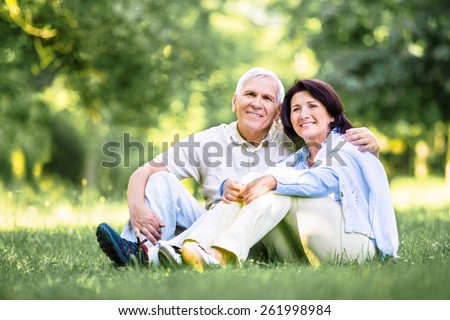 Old. happy Mature couple walks in the park in summer day