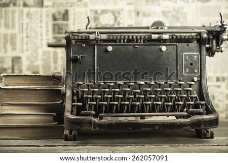 Book. Vintage typewriter, old books on table sepia photo
