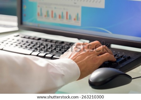 Hand. Hand Typing at a Computer