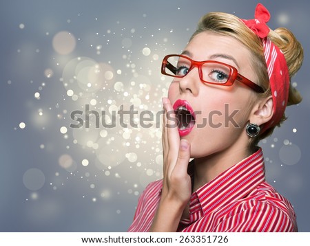 Girl. Charming pin-up woman with retro hairstyle and make-up sending a kiss.