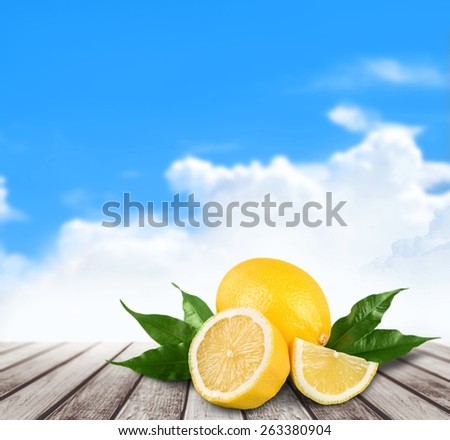 Fruit. Heap of fresh yellow lemons with green leaf. Placed on white background. Close-up. Studio photography.