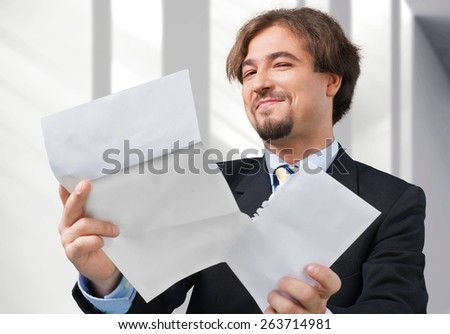 Shock. Man Opens Letter with Shocked Expression