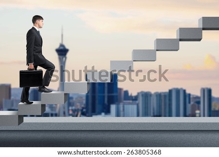 Achievement. Businessman stepping up a staircase and city