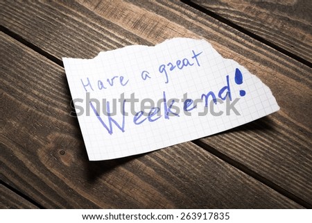 Weekend. Have a great Weekend - Hand writing text on a piece of paper on wood background