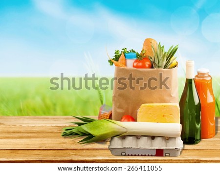 Supermarket. Brown table and on background blured supermarket and bag with products