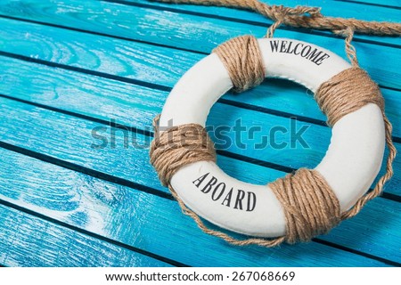 Curriculum. We are hiring ! - Welcome on Board - Lifebuoy with fishnet and blue text on wooden background