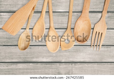Background. Border of wooden kitchen utensils  on white background