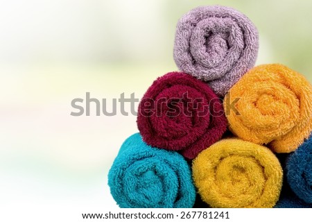 Towel. Five rolled multicoloured bath towels isolated on white