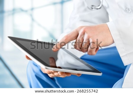 User. Close-shot of male hands holding a tablet in hands