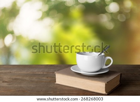Tea. Cup of coffee and book on wooden table