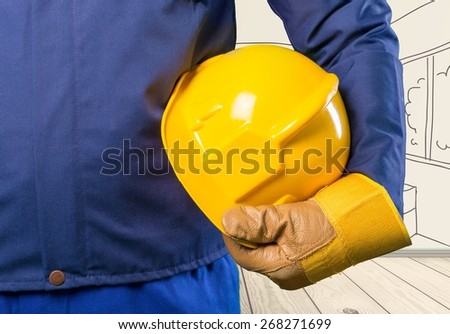 Yellow. Hand of worker with yellow hard-hat,natural light