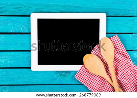 Kitchen. Blackboard on wooden surface and serving spoons
