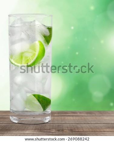 Vodka. Cocktail with ice and lime slice isolated on white background