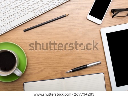 Business. Office supplies, devices, coffee cup and apple on wooden table