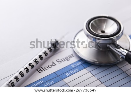 Blood. Stethoscope and a syringe on a diabetes test