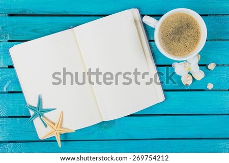 Note. Workspace with coffee cup, instant photos, note paper and notebook on old wooden table
