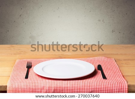 Plate. Empty plate with fork and knife on wooden table. Table arrangement.
