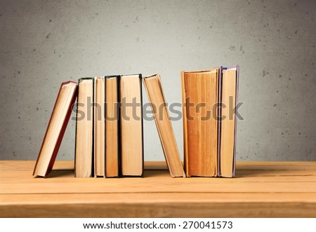 Book. Vintage books on wooden table over retro wallpaper background
