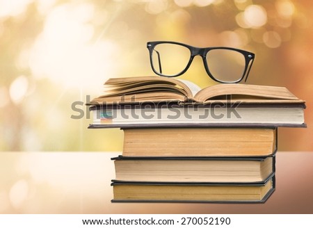 Analyze. Picture of a pile of books and eyeglasses, with a retro effect