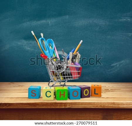 Education. Back to School Shopping Cart with Supplies on White Background