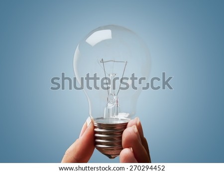 Light Bulb. Hand with lamp and plant