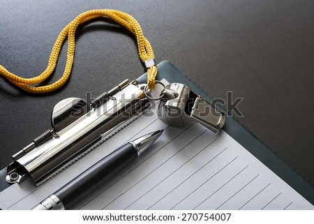 Coach. Metal sport whistle with pen and paper sheet