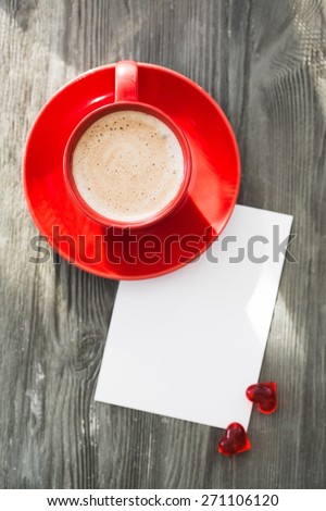 Card. Blank valentines greeting card and red coffee cup on wooden background